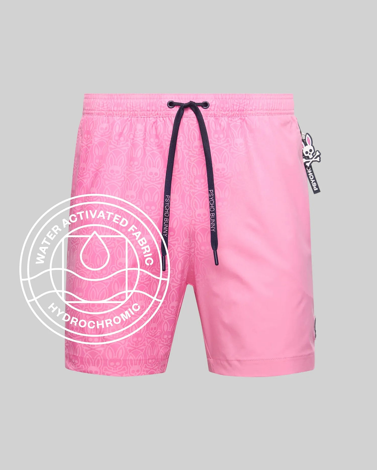 Mens Samos Hydrochromic Printed Swim Trunk in vibrant pink, featuring a subtle water-activated bunny skull pattern, navy drawstring with Psycho Bunny text, and a small logo tag.