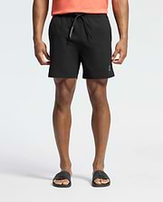 Mens Samos Hydrochromic Printed Swim Trunk in black, featuring a classic fit, smooth quick-dry fabric, a drawstring with white Psycho Bunny text, and a subtle white bunny skull logo on the lower left leg.