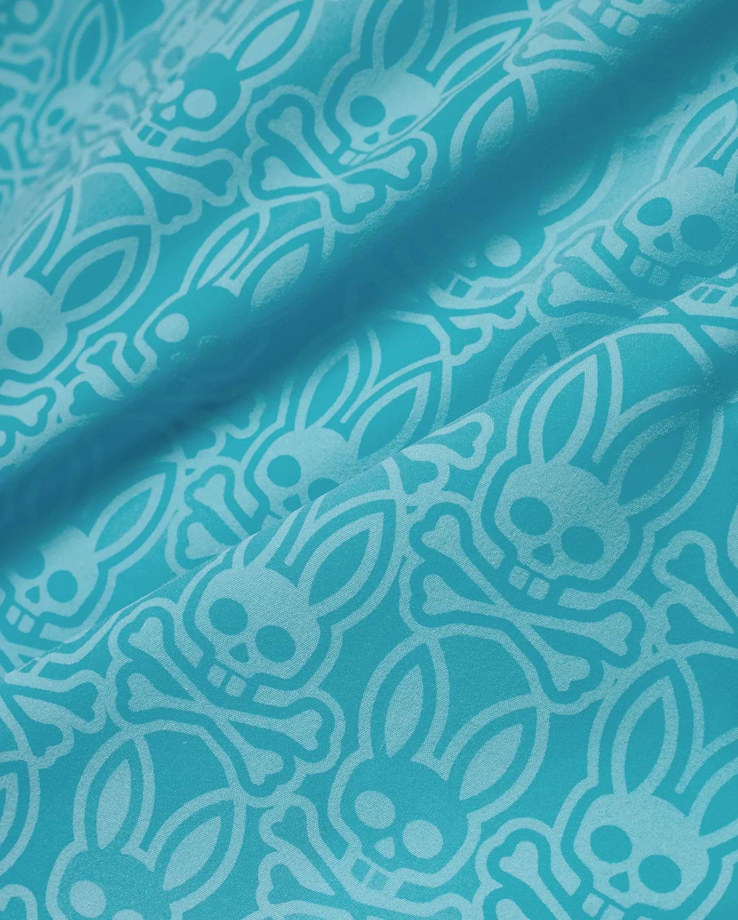 Mens Samos Hydrochromic Swim Trunks in vibrant teal, featuring a tone-on-tone all-over pattern of the iconic Psycho Bunny skull and crossbones logo on a smooth, durable swim fabric. (7)