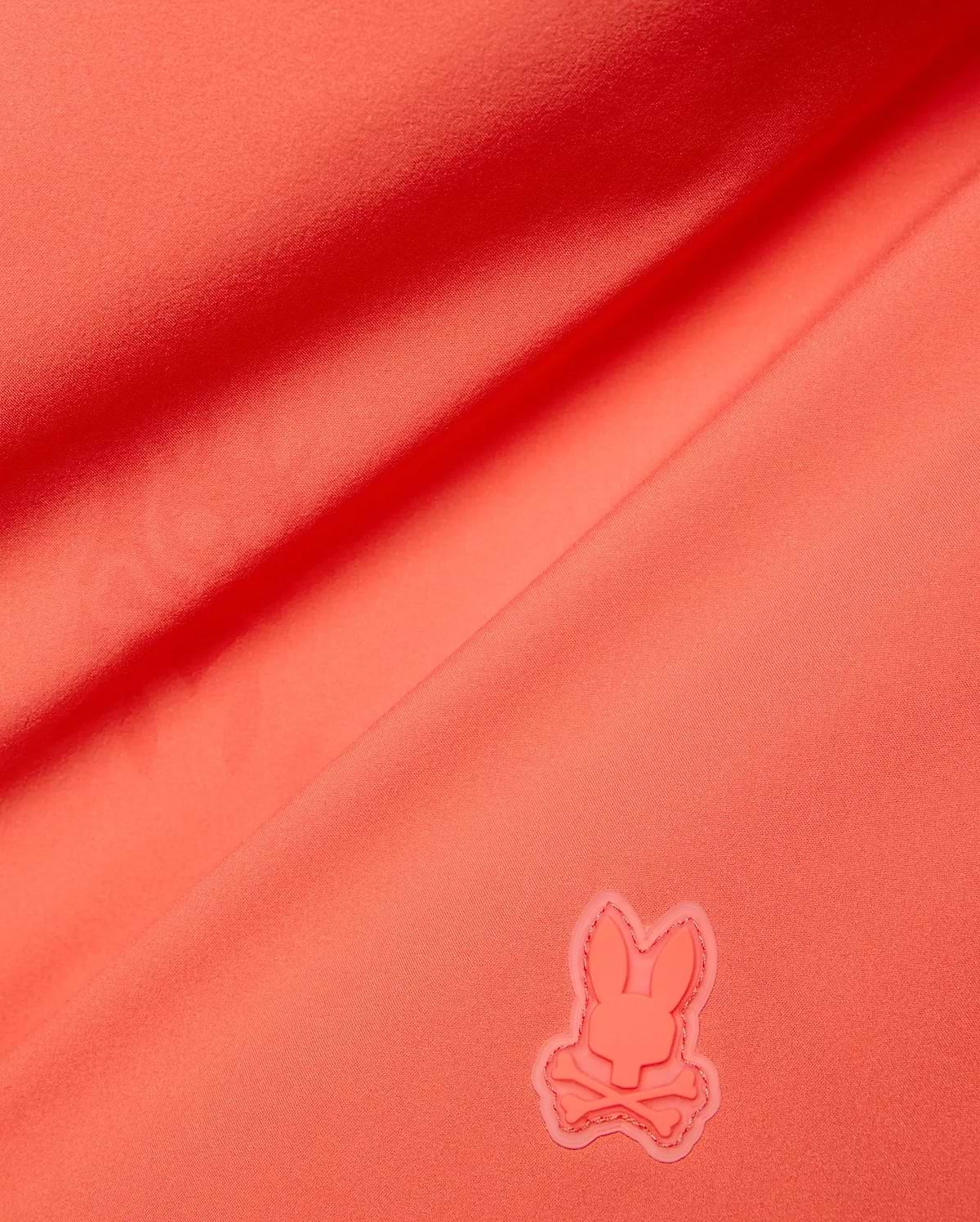 Vibrant Coral Mens Samos Hydrochromic Printed Swim Trunk, crafted from smooth premium swimwear fabric, featuring a raised tonal rubberized Psycho Bunny skull logo.