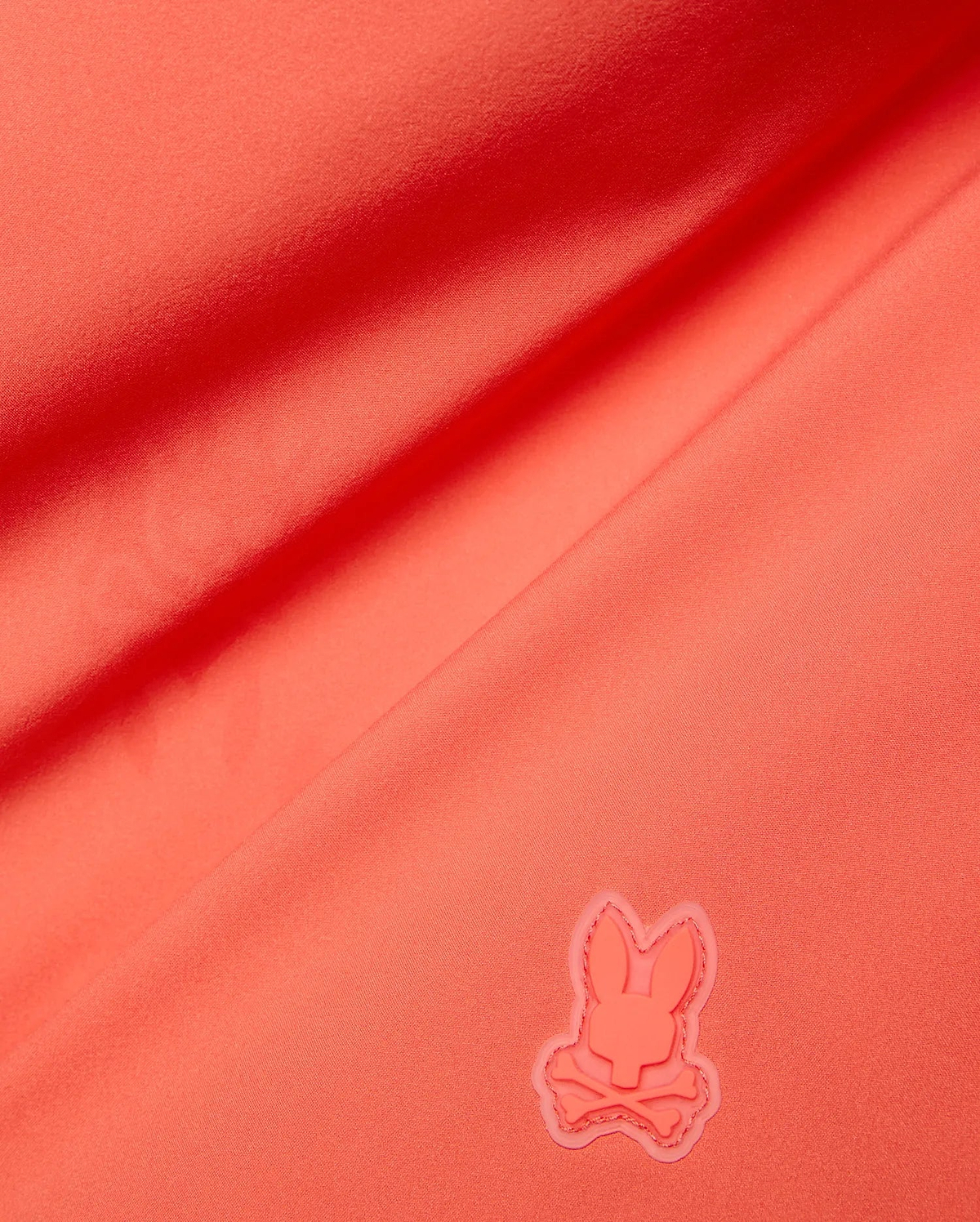Vibrant Coral Mens Samos Hydrochromic Printed Swim Trunk, crafted from smooth premium swimwear fabric, featuring a raised tonal rubberized Psycho Bunny skull logo.
