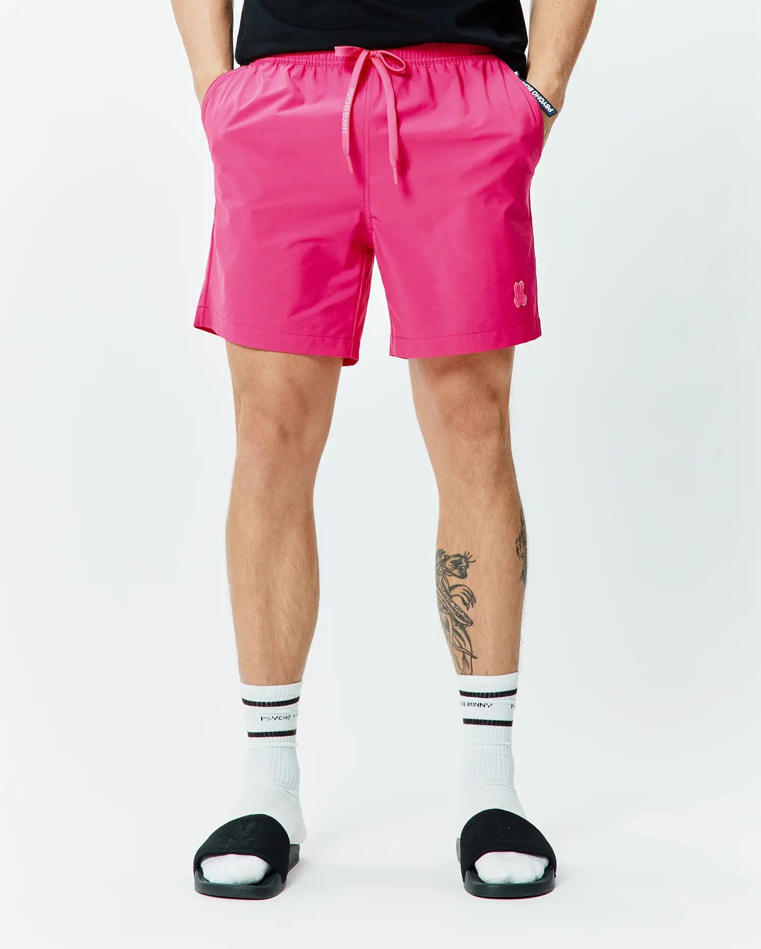 Mens Samos Hydrochromic Printed Swim Trunk 6, vibrant pink, with elastic drawstring waist, side pockets, small embroidered bunny skull logo, and Psycho Bunny tag. Relaxed fit, smooth quick-dry fabric. (3)