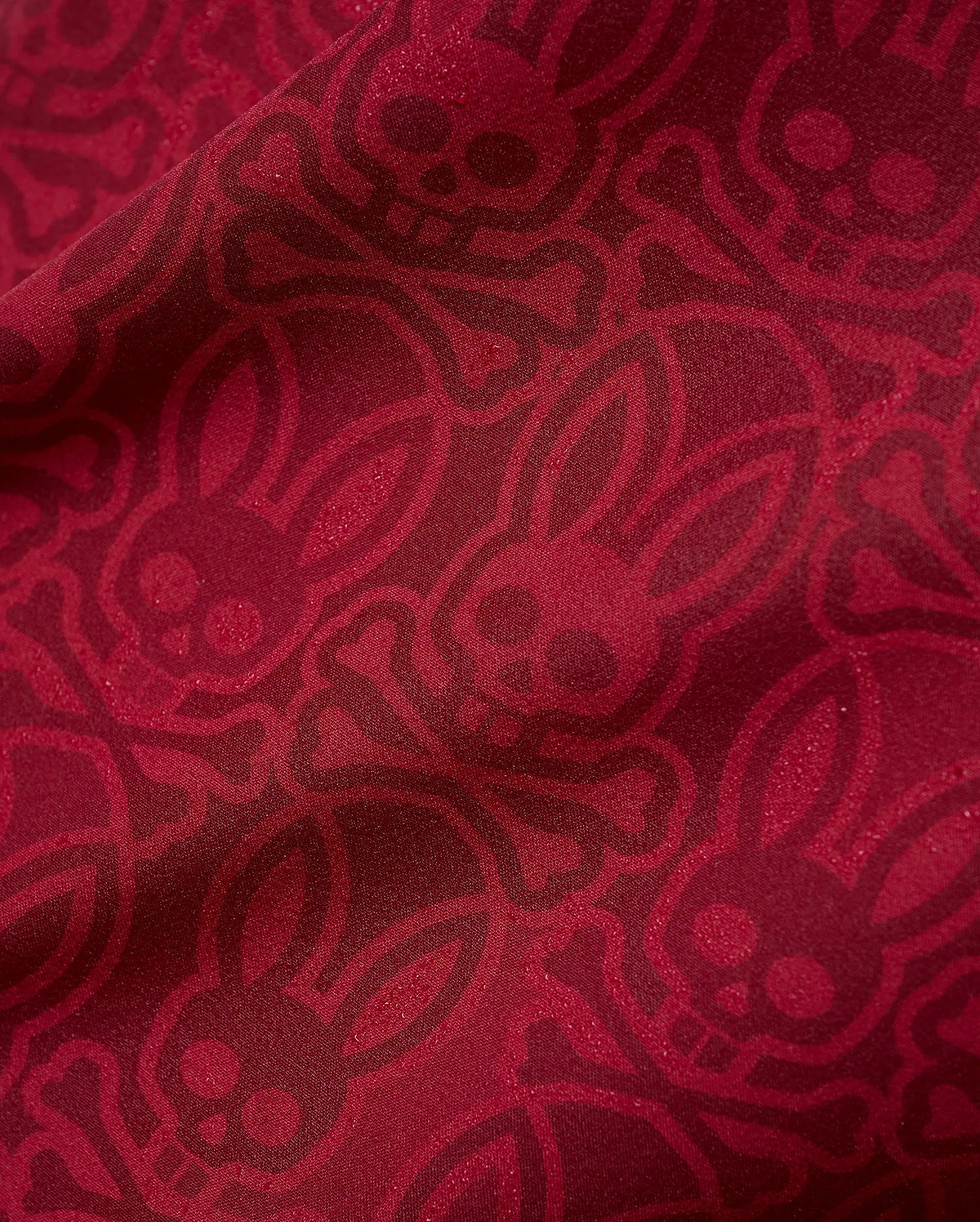 Mens Samos Hydrochromic Printed Swim Trunk in rich red, featuring an all-over darker red hydrochromic Psycho Bunny skull and crossbones pattern on smooth fabric. (7)