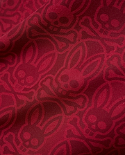 Mens Samos Hydrochromic Printed Swim Trunk in rich red, featuring an all-over darker red hydrochromic Psycho Bunny skull and crossbones pattern on smooth fabric. (7)