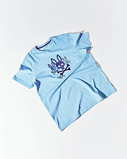 Mens Oscar Graphic Tee, a sky blue classic fit jersey knit t-shirt featuring a large central graphic of purple and dark blue bunny skulls, crossbones, and white Psycho Bunny script. (1)