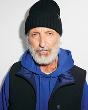 Black ribbed knit MENS BROGAN BEANIE with a subtle bunny skull logo patch, layered over a royal blue relaxed fit french terry hoodie and a black full-zip vest with a dark blue collar and branded snap button.