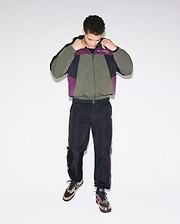 Olive, black, and purple colorblock crinkled nylon windbreaker jacket with Psycho Bunny chest text logo, paired with matching Mens Alder Nylon Colorblock Pant featuring side stripes and an embroidered bunny skull.