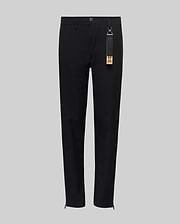 The Psycho Bunny KIDS MATHIEU COMMUTER PANT (KB0600002) features a black straight-leg, classic fit with waistband, button and front zipper. A black tag with keychain and orange label hangs from a belt loop. Shown on a light gray background.