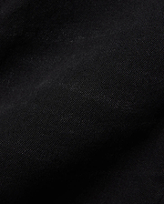 Kids Emerson Denim Pant, showcasing the rich, deep black denim fabric with a distinct diagonal twill weave texture. The premium quality material is subtly creased, highlighting its refined finish.