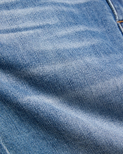 Kids Emerson Denim Pant featuring a classic medium blue washed denim with a prominent twill weave texture, natural fading, and subtle creasing, accented by visible warm brown stitching. (6)