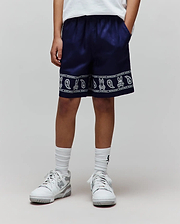 Kids Luke Tencel Short in navy, featuring a relaxed fit and a white bandana print border at the hem with alternating Psycho Bunny skull logos and paisley motifs, framed by Psycho Bunny text.