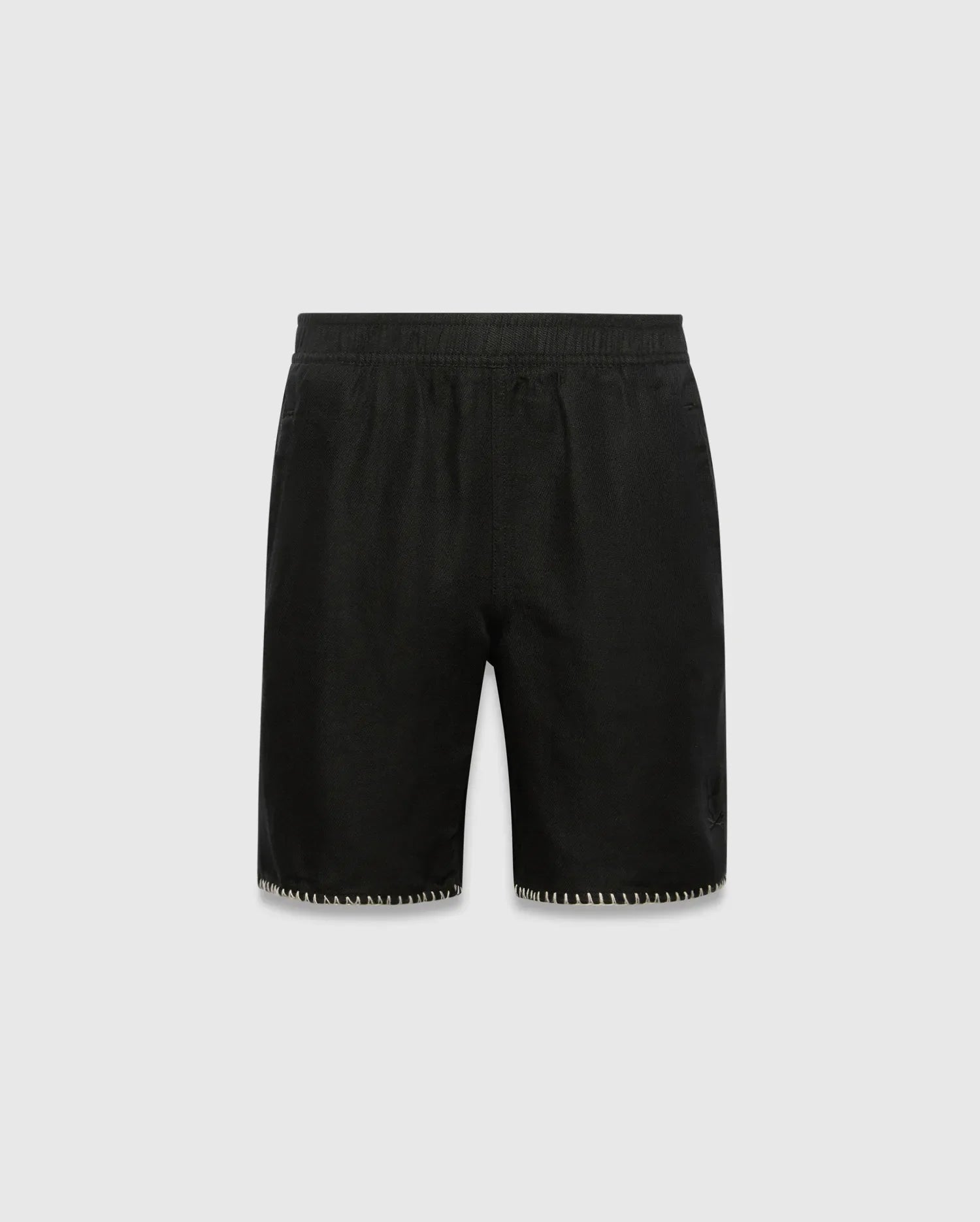 Kids Brad Linen Short, black relaxed fit with linen texture, featuring a subtle tonal embroidered Psycho Bunny skull logo on the lower right leg and white contrast blanket stitching on the hem.