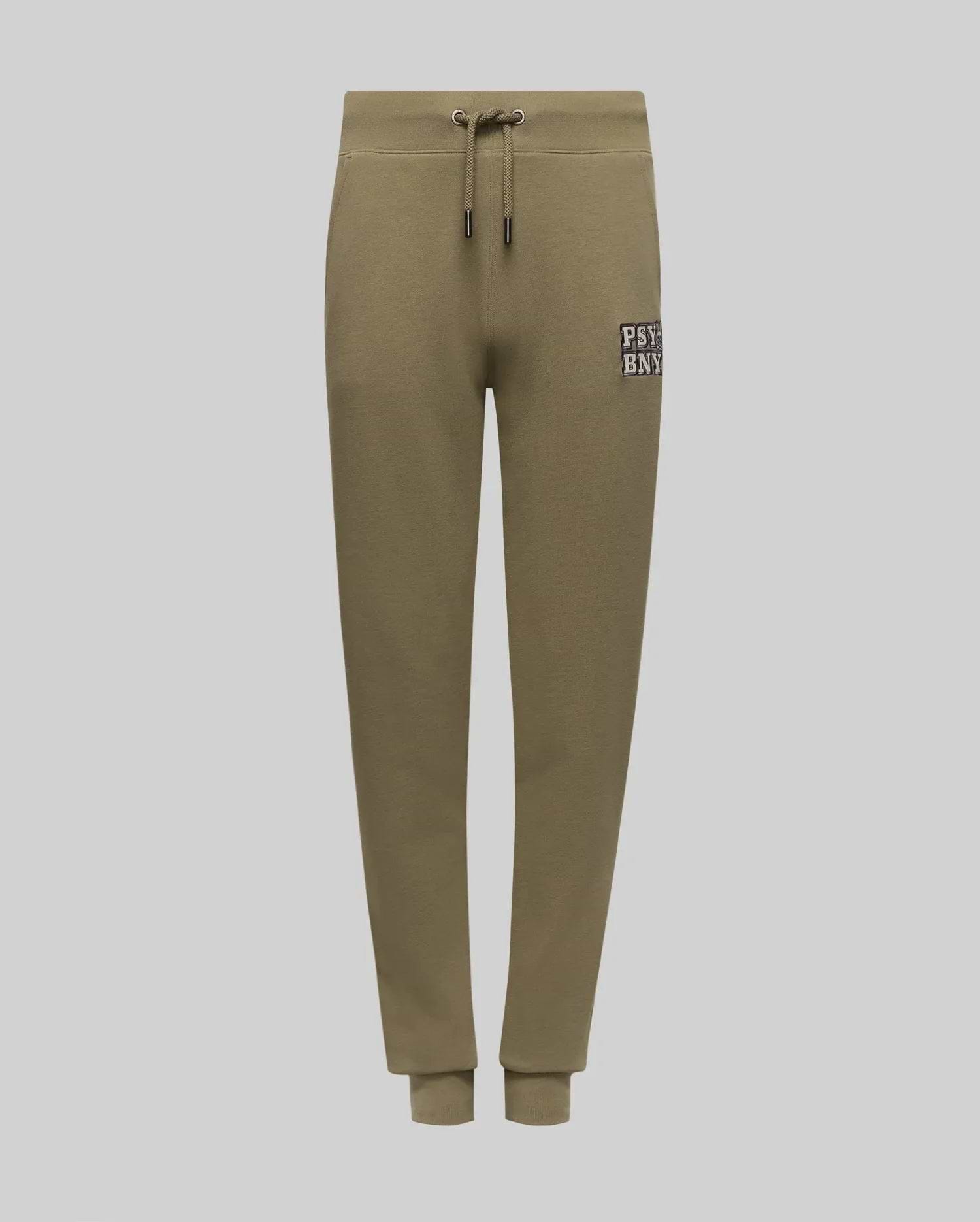 The KIDS WADE CORD PATCH SWEATPANT (KB0800002) by Psycho Bunny is an olive green jogger with a drawstring waist, ribbed cuffs, side pockets, and a white "PSBNY" logo on the left thigh. Made from premium cotton blend.