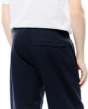 Kids Darcy Sweatpant in navy, crafted from soft French terry fabric. Features a relaxed fit, side pockets, and a back welt pocket with a subtle black pull tab.