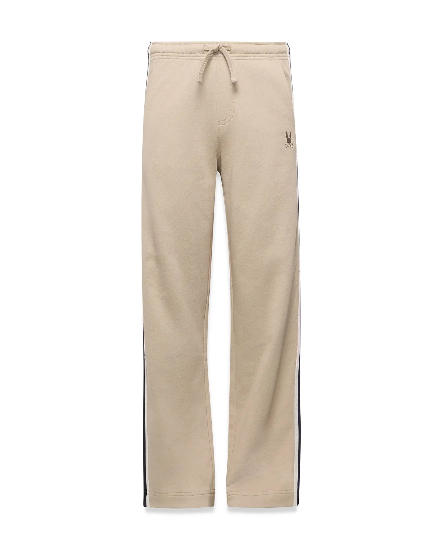 Kids Ty French Terry Sweatpant in beige, featuring a relaxed fit, drawstring waist, navy and white side stripes, and a small embroidered Psycho Bunny skull logo on the upper right thigh.