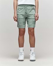 Teen | The lower half of a person is shown wearing Psycho Bunny KIDS KELVIN TOWEL TERRY SWEATSHORT - KB0900002 in mint green, paired with white crew socks and sneakers against a plain background.
