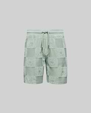 The Psycho Bunny KIDS KELVIN TOWEL TERRY SWEATSHORT (KB0900002) features light green cotton-blend jacquard terry, with a drawstring waist and a checkered pattern of alternating solid/textured squares and playful bunny heads.