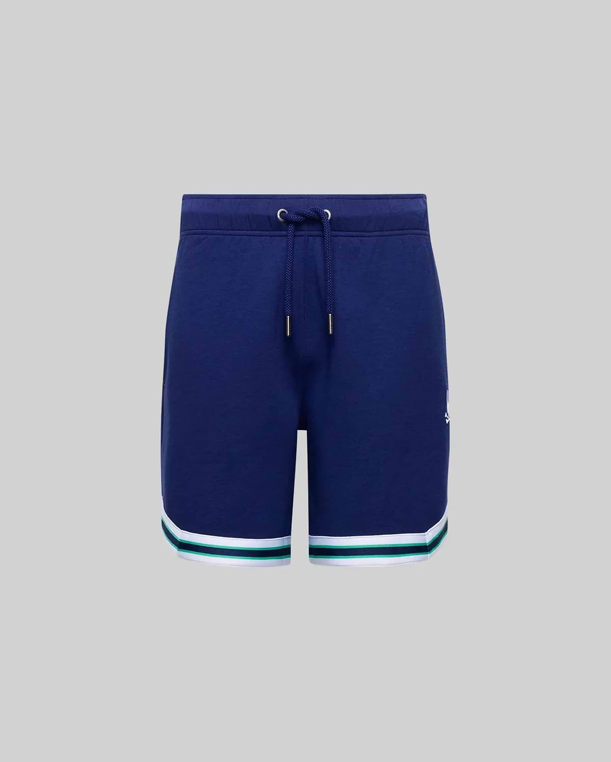 The KIDS BASIL TAPED SHORT (KB0900003) by Psycho Bunny features a navy blue cotton-modal blend with a drawstring waist and white and green striped hems, shown against a plain gray background.