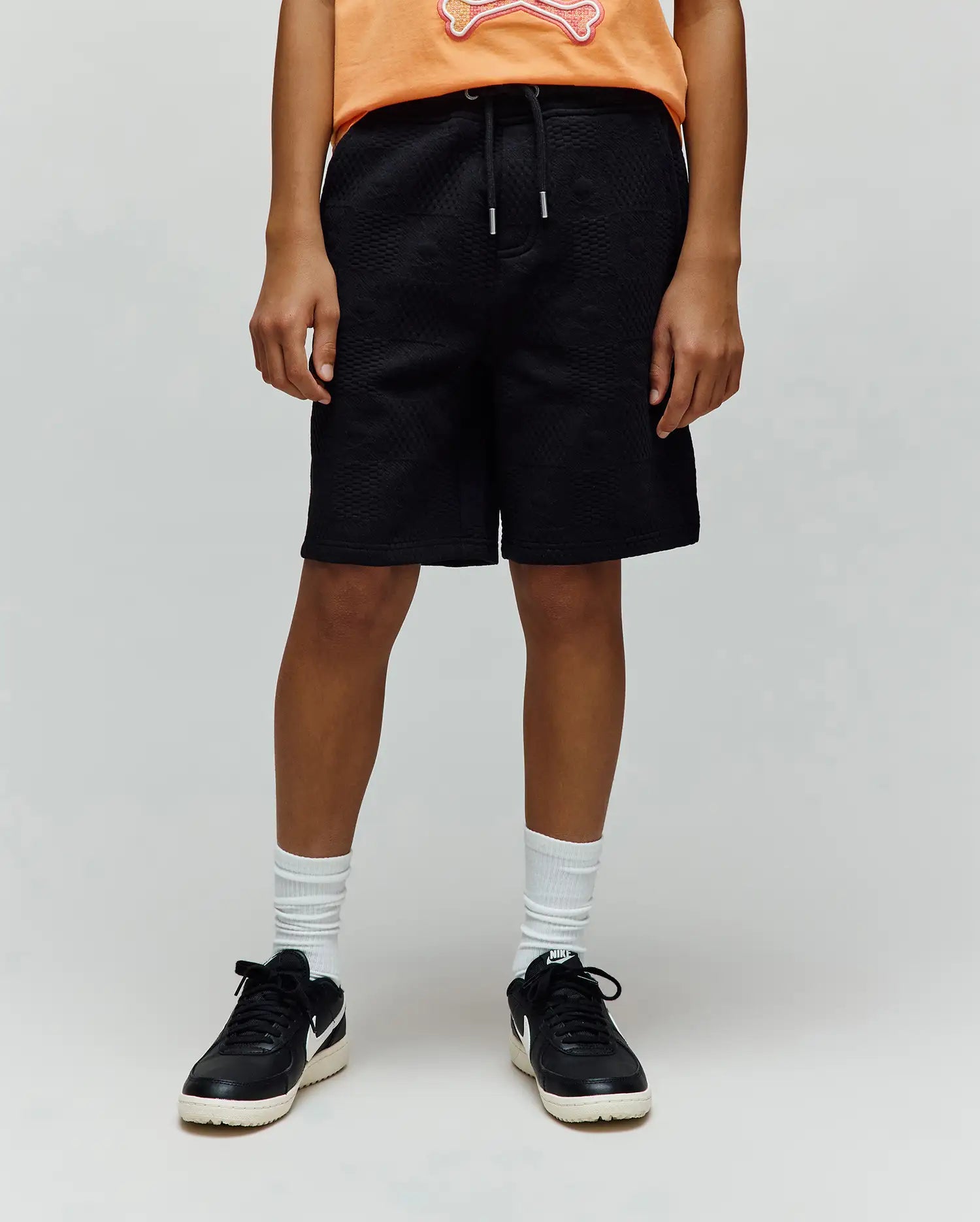 Kids Dustin Sweatshort in black, crafted from a premium textured knit fabric with a subtle all-over quilted pattern, offering a comfortable relaxed fit and an adjustable drawstring waist. (1)