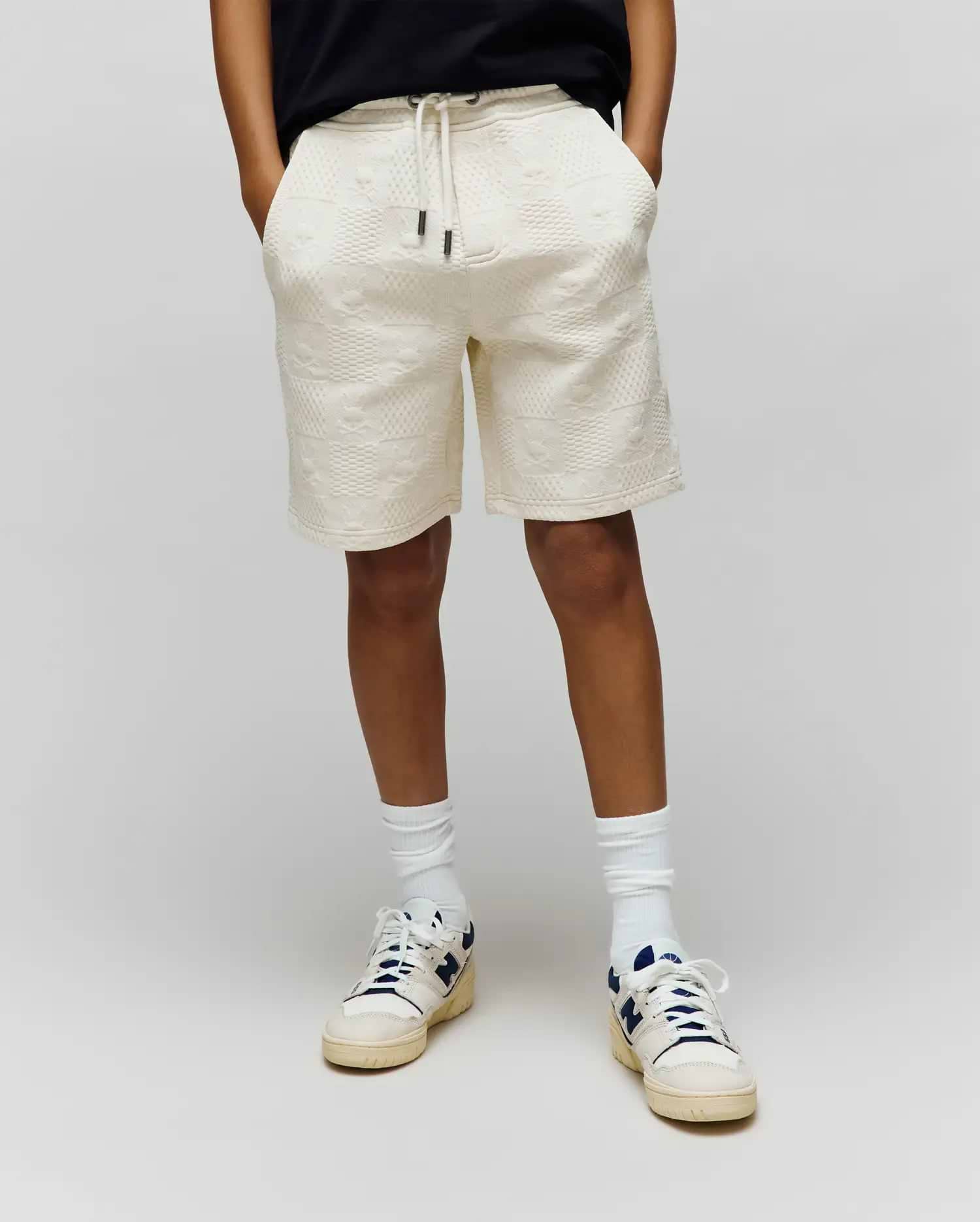 Kids Dustin Sweatshort in cream, featuring a relaxed fit and an all-over embossed bunny skull and geometric textured knit pattern, with a drawstring waist.