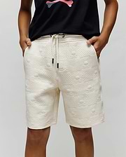 Kids Dustin Sweatshort in cream, featuring a relaxed fit and textured jacquard fabric with an all-over embossed checkerboard pattern of small Psycho Bunny skull logos. Dark drawstring tips.