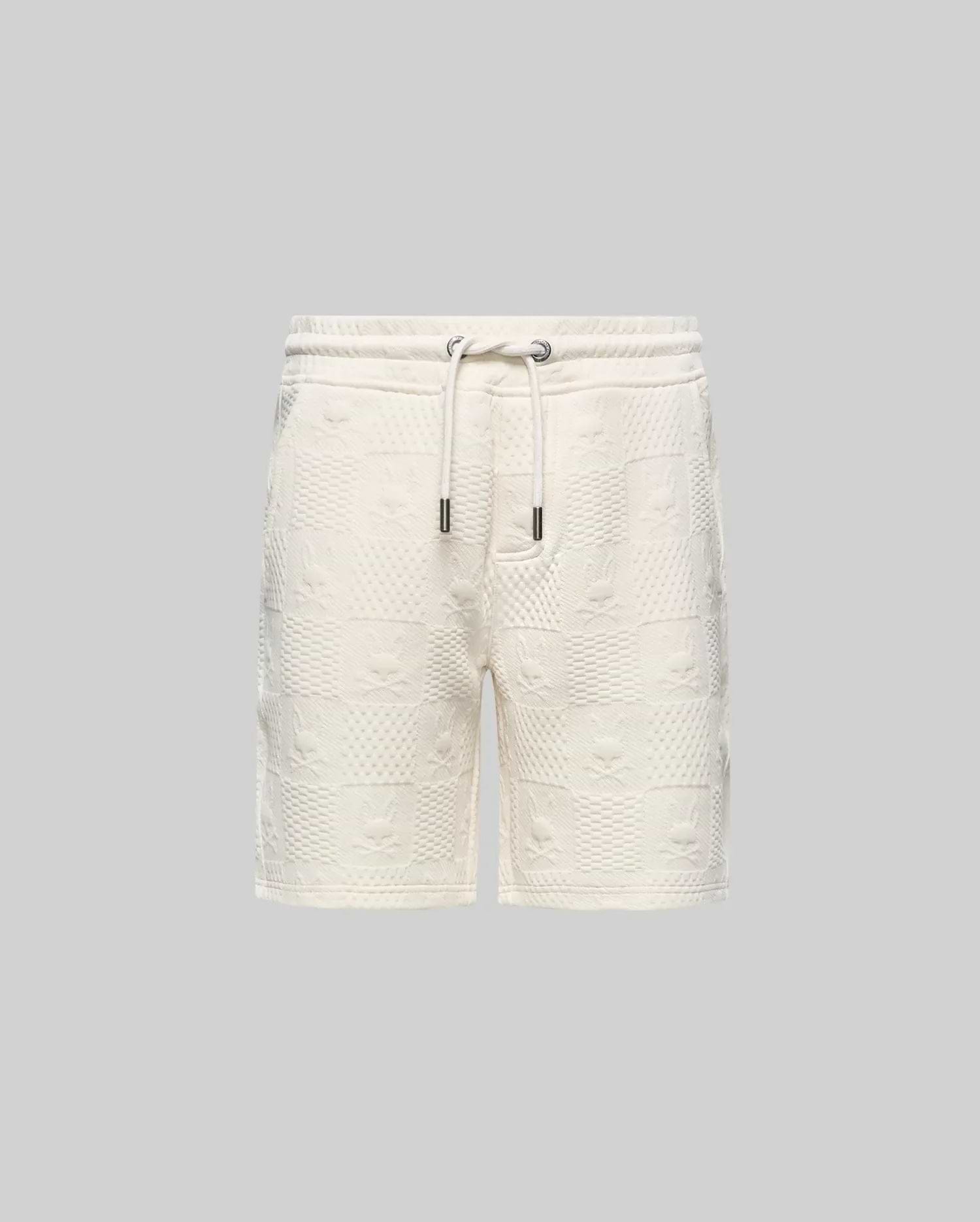 Kids Dustin Sweatshort, cream textured knit with a relaxed fit. Features an all-over embossed checkerboard pattern of Psycho Bunny skull logos and geometric squares.