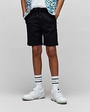Kids Barry Modal Short, black relaxed fit shorts with a drawstring waist, silver tips, side pockets, and a tonal embroidered Psycho Bunny skull logo on the left thigh.