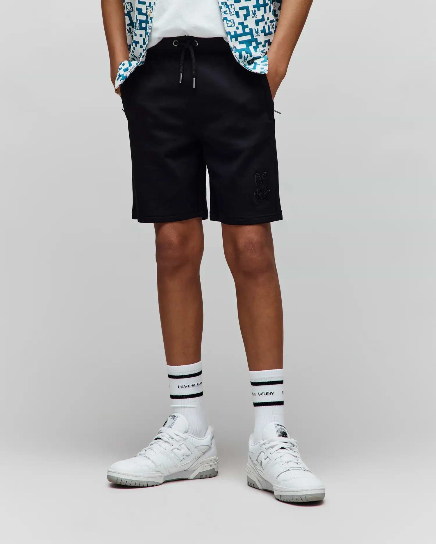 Kids Barry Modal Short, black relaxed fit shorts with a drawstring waist, silver tips, side pockets, and a tonal embroidered Psycho Bunny skull logo on the left thigh.