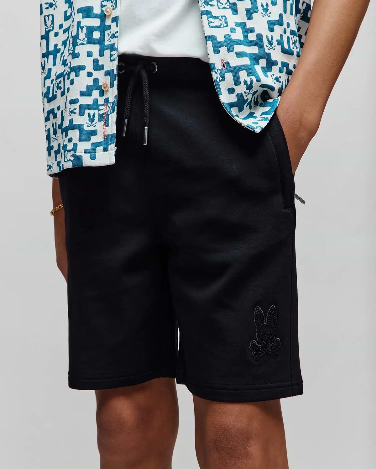 Kids Barry Modal Short in black, a relaxed fit, smooth modal blend fabric, featuring a drawstring waist with silver tips and a tonal embroidered Psycho Bunny skull logo on the left leg.