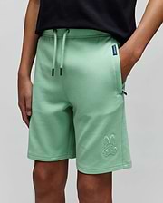 Kids Barry Modal Short in mint green, featuring a relaxed fit, soft modal fabric, drawstring waist, and a large embroidered Psycho Bunny skull logo on the left leg, plus a small navy brand tag. (2)