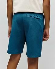 Kids Barry Modal Short in deep teal, featuring a relaxed fit, soft modal knit fabric, and a back welt pocket with a small black Psycho Bunny tag.