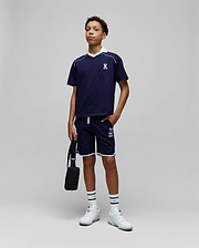 Navy blue jersey t-shirt with white V-neck collar, piping, and embroidered Psycho Bunny logo on chest, paired with Kids Toby Short in navy, featuring white piping and large PSYCHO BUNNY graphic.
