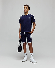 Navy blue jersey t-shirt with white V-neck collar, piping, and embroidered Psycho Bunny logo on chest, paired with Kids Toby Short in navy, featuring white piping and large PSYCHO BUNNY graphic.