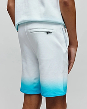 Kids Dax Sweatshort in soft white french terry, featuring a vibrant turquoise ombre fade on the legs, classic fit, and a small black Psycho Bunny logo tag on the back pocket.