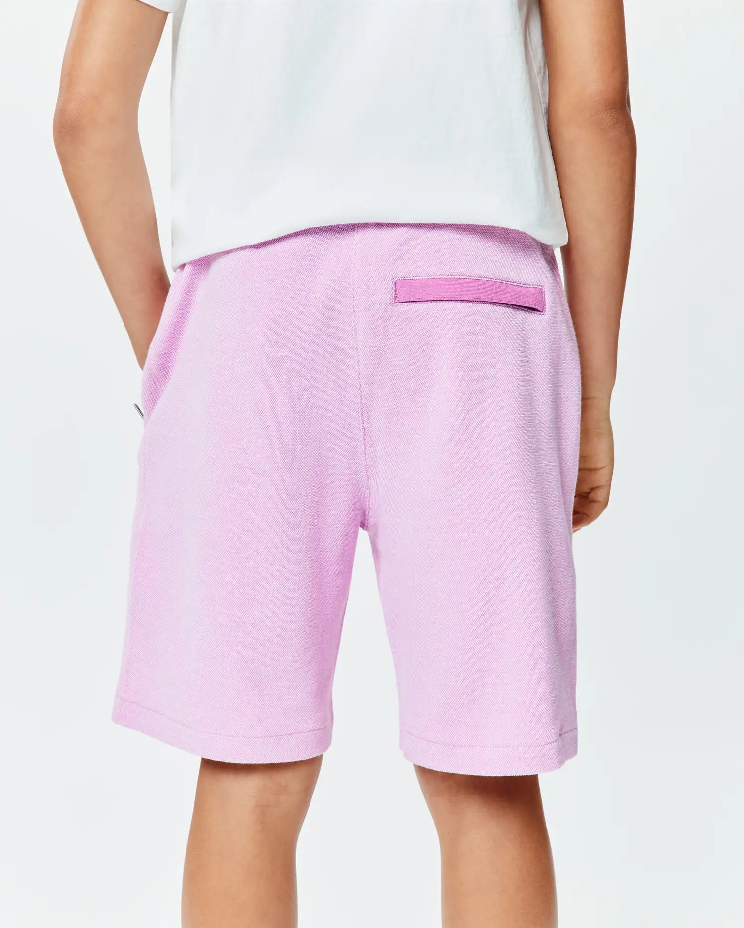 Kids Keith Short, a premium relaxed fit light pink pique knit short featuring a subtle darker pink back loop, embodying Psycho Bunny's refined streetwear. (2)