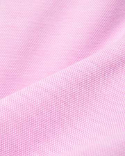 Psycho Bunny Kids Keith Short, a premium streetwear garment, features a vibrant pink pique knit fabric with a distinct textured weave, reflecting the brand's bold color aesthetic. (5)