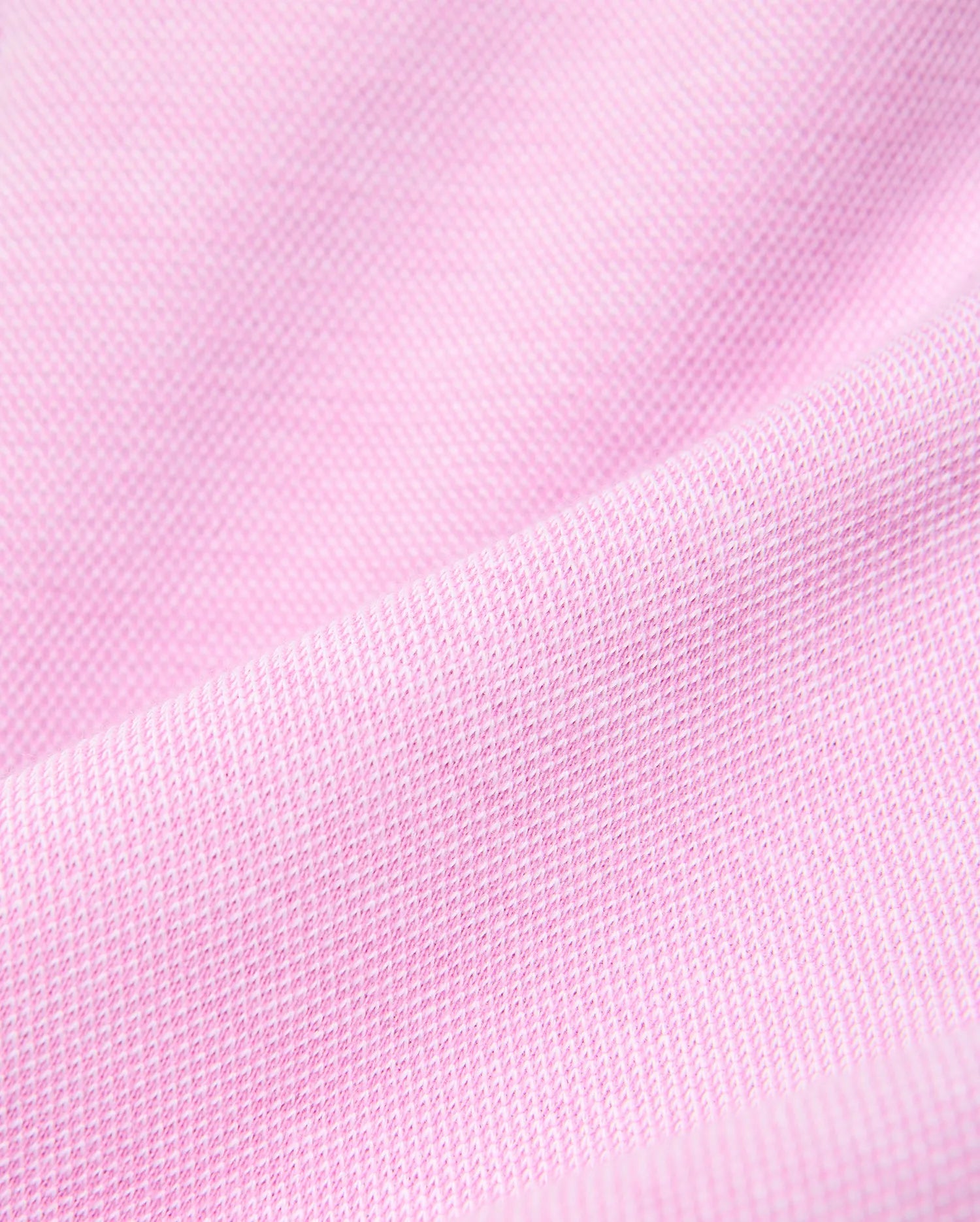 Psycho Bunny Kids Keith Short, a premium streetwear garment, features a vibrant pink pique knit fabric with a distinct textured weave, reflecting the brand's bold color aesthetic. (5)