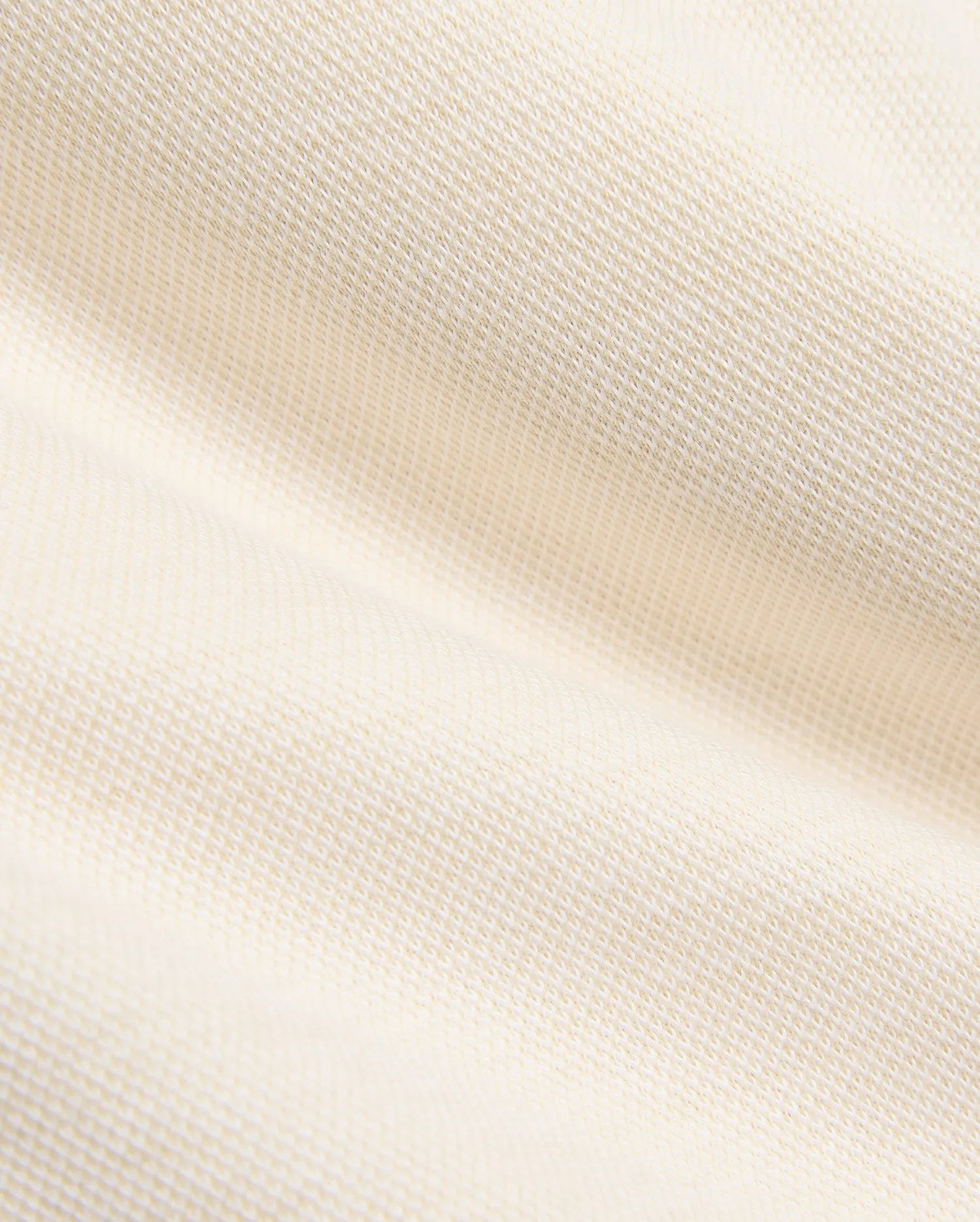 Kids Keith Short 3 1/2 in a soft, luxurious cream hue, showcasing a finely woven, subtly textured pique knit fabric, reflecting Psycho Bunny's premium streetwear craftsmanship.