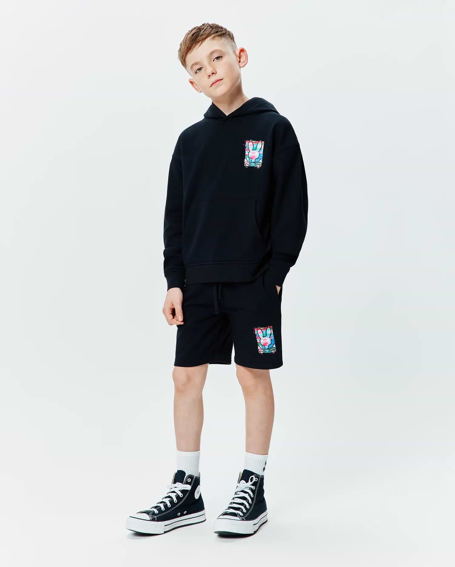 Black relaxed fit French terry hoodie with a vibrant multi-color Psycho Bunny skull graphic on the left chest, paired with matching Kids Isaac Print Short featuring the same graphic on the left leg and a drawstring waist.