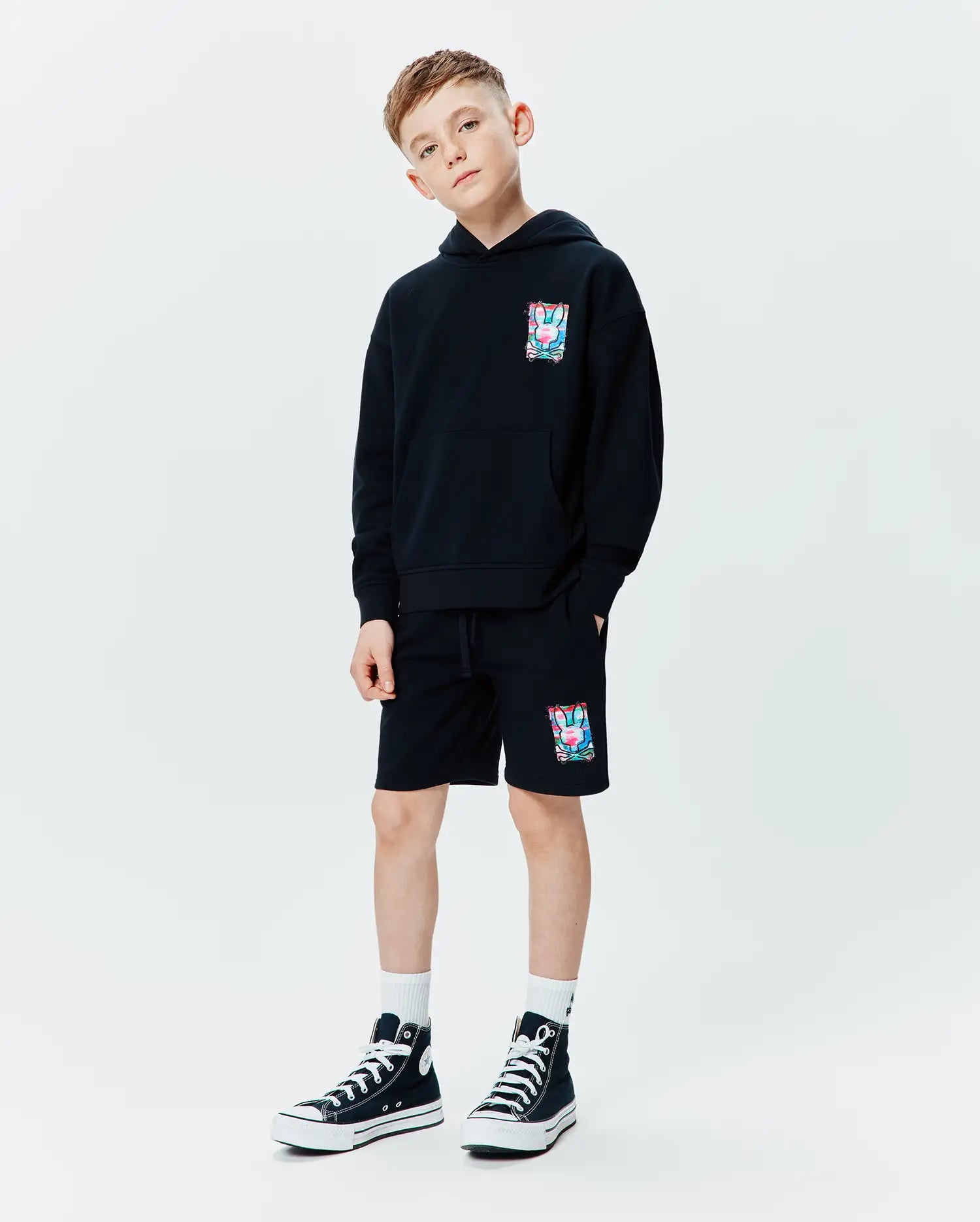 Black relaxed fit French terry hoodie with a vibrant multi-color Psycho Bunny skull graphic on the left chest, paired with matching Kids Isaac Print Short featuring the same graphic on the left leg and a drawstring waist.