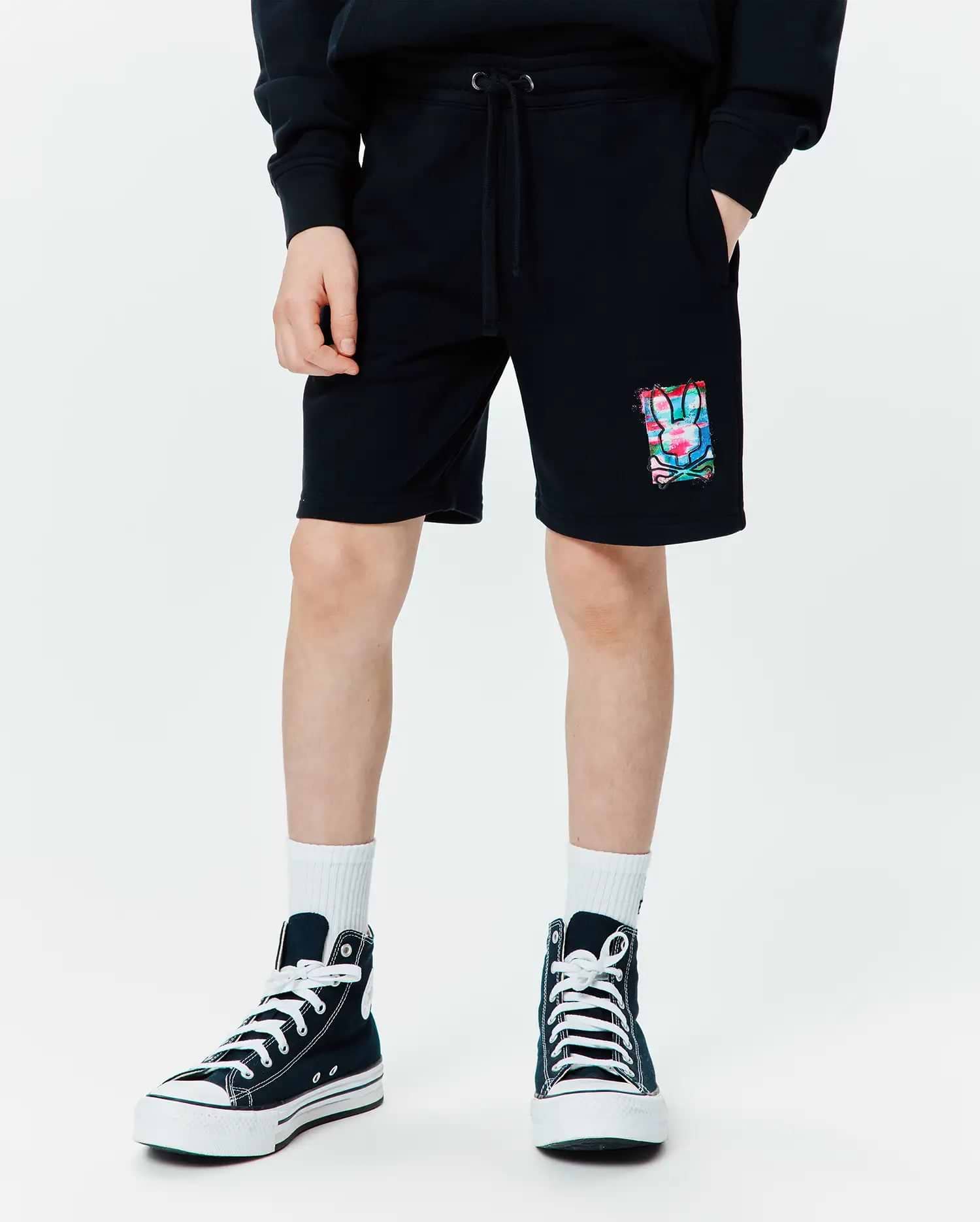 Kids Isaac Print Short, black relaxed fit French terry shorts with a drawstring waist, pockets, and a vibrant abstract multi-color bunny skull graphic print on the left leg.