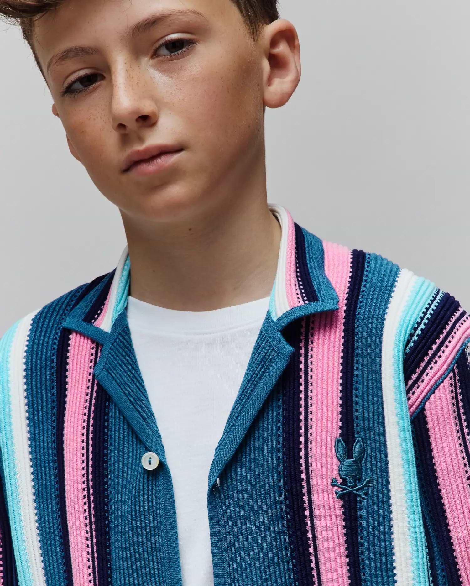 Kids Cliff Knit Shirt featuring a classic fit, ribbed knit texture, and bold vertical stripes in navy, blue, pink, and white, with a small embroidered Psycho Bunny logo on the left chest. (3)