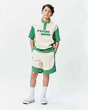 Premium Psycho Bunny cream and green color block polo shirt with bold chest text, paired with matching soft knit Kids Kelly Short featuring a subtle embroidered bunny skull logo.