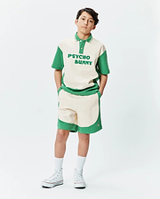 Premium Psycho Bunny cream and green color block polo shirt with bold chest text, paired with matching soft knit Kids Kelly Short featuring a subtle embroidered bunny skull logo.