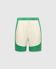 Kids Kelly Short, a relaxed fit green and cream color-block short in soft jersey fabric, featuring a small embroidered Psycho Bunny skull logo on the lower right leg.