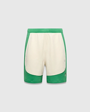 Kids Kelly Short, a relaxed fit green and cream color-block short in soft jersey fabric, featuring a small embroidered Psycho Bunny skull logo on the lower right leg.