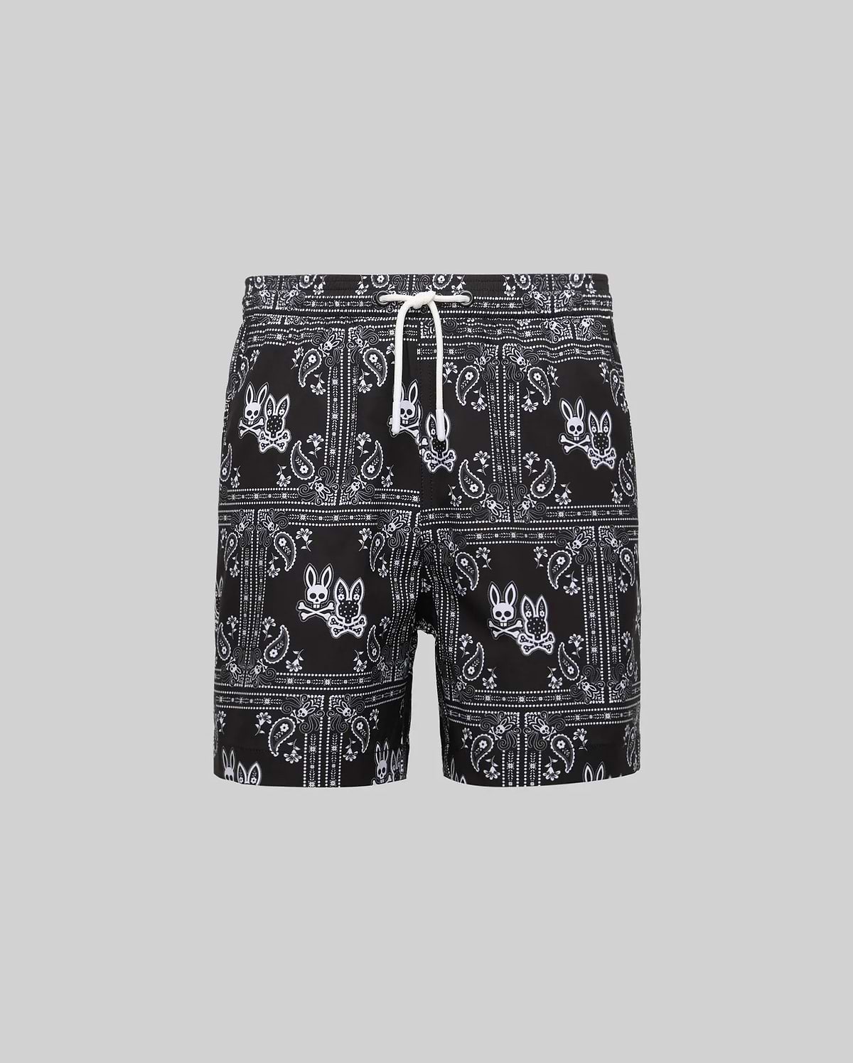 Kids Luke Swim Trunk, black classic fit swim trunks with an all-over white bandana paisley pattern featuring repeated Psycho Bunny skull logos and a white drawstring.