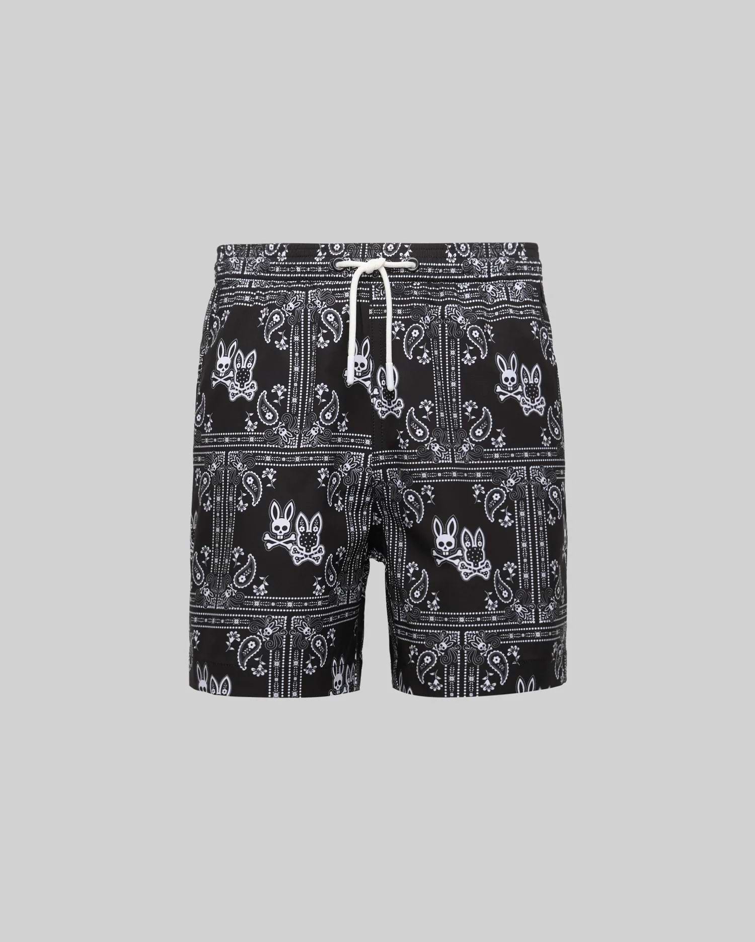 Kids Luke Swim Trunk, black classic fit swim trunks with an all-over white bandana paisley pattern featuring repeated Psycho Bunny skull logos and a white drawstring.
