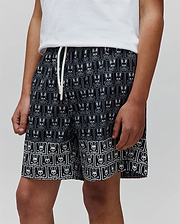 Kids Keon Swim Trunk, black relaxed-fit swim shorts featuring an all-over white Psycho Bunny skull and crossbones pattern, a distinct border design, and a white drawstring with Psycho Bunny text.