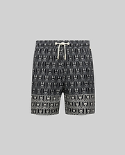 Kids Keon Swim Trunk in black, featuring a relaxed fit and a bold all-over white Psycho Bunny skull and crossbones logo pattern with a contrasting white drawstring.